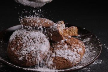 oatmeal cookies on a black table in castor sugar