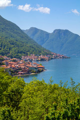 Fototapeta na wymiar holidays in Italy - a view of the most beautiful lake in Italy with town in background, Lago di Como, Lombardy, Italy