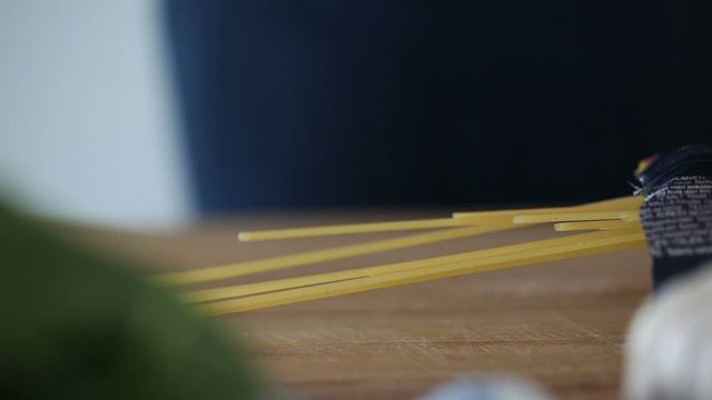 The female hand gets pasta from packing.