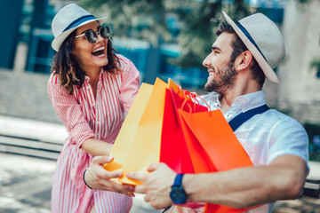 Couple having fun outdoor while doing shopping together
