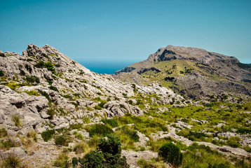 Fototapeta na wymiar Field mountain landscapes. Seascape beyond the mountains. Majorca, Spain