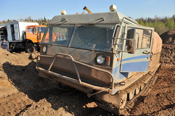 Heavy cargo vehicle on the tracks. Crawler. Tractor. The swamp-hunter. Russia, summer.