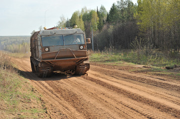 Heavy cargo vehicle on the tracks. Crawler. Tractor. The swamp-hunter. Russia, summer.