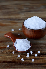 Big sea salt in a wooden bowl and spoon