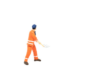 Miniature people worker wearing safety construction on white background with a space for text