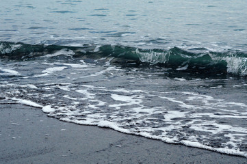 Wave on the shore. Background image in dark colors