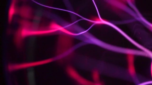Plasma ball lamp, Tesla Coil experiment with electricity, plasma lamp closeup. Abstract backdrop. Slow motion 4K UHD video 3840X2160