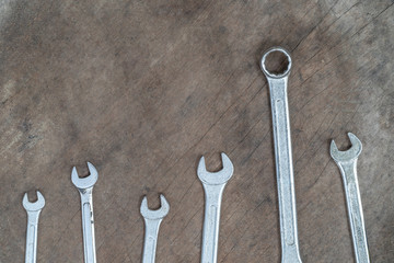 Old wrench on wood background