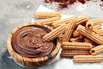 Traditional Spanish dessert churros with sugar and chocolate