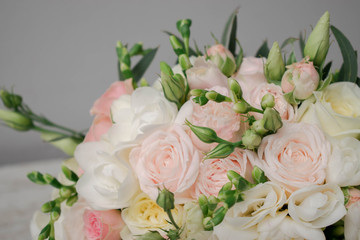 Wedding bouquet made of white roses, freesia, lisianthus.