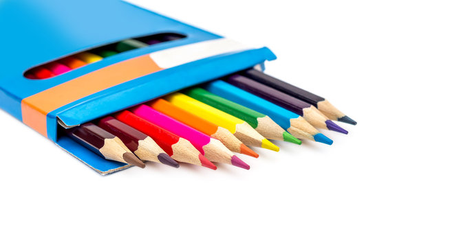 Colored pencils in carton pencil box on white.