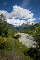 Fototapeta na wymiar Hiking through the dramatic scenery of Svaneti, Georgia. Dramatic landscapes.