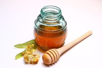 Honey in a glass jar on a white background