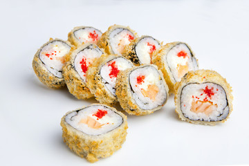 a portion of ten rolls with salmon and red caviar are on the plate in the cafe