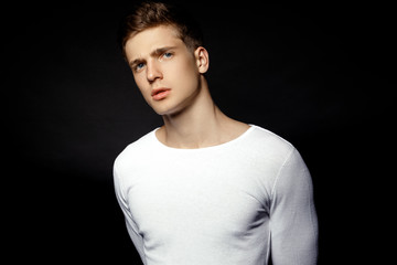 Male in white sport suit on black background