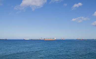 Blue sea with many ships in a sunny day.