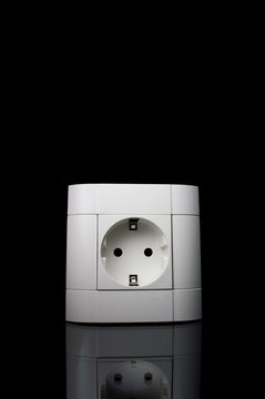 White electric socket on a wall