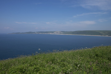 view of Puttsborough Sands and Woolacombe beach with the sea beyond and blue sky on a sunny day in the summer. North Devon, United Kingdom