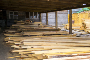 Sawmill. Warehouse for sawing boards on a sawmill outdoors. Wood timber stack of wooden blanks construction material