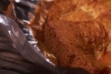 Tart with apricots on wooden table background close up