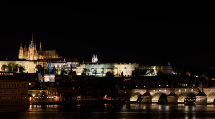 Fototapeta na wymiar Night view from, the Vltava river in Prague, Hradcany Prague castle and the Charles bridge