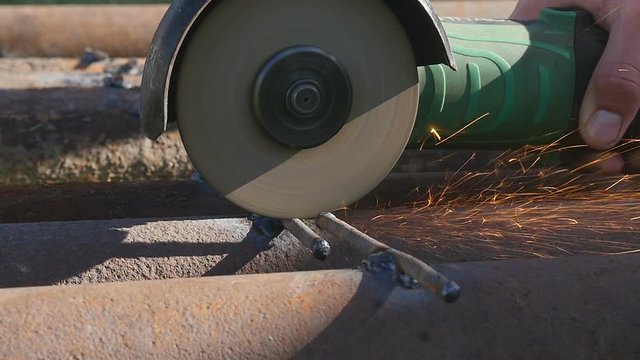 Man Chlef and smooth surface. Man worked over the steel. close-up of hand and electric saws metal. Close-up of hand tool.