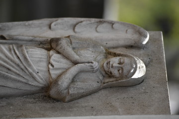 Sculpture of a grieving angel on an old tomb of the cemetery of Montreal-Canada