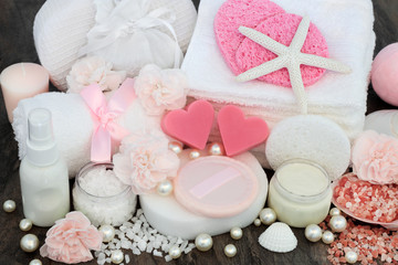 Skin care and ex foliation beauty treatment with himalayan ex foliating salts, heart shaped pink soaps, sponges, face cloths, body lotion, moisturising cream, decorative shells and pearls.