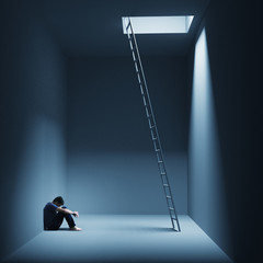 Ein Mann sitzt depressiv in einem Raum mit Leiter - obrazy, fototapety, plakaty