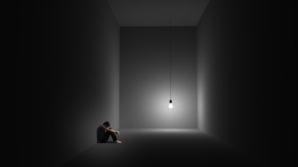 A man is sitting depressively in a room with a lightbulb - obrazy, fototapety, plakaty