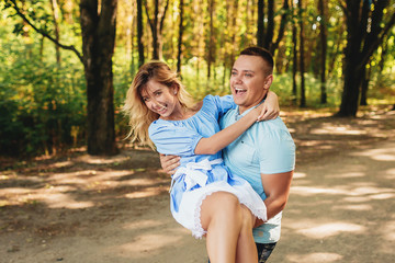 Fototapeta premium Loving young couple in the park dancing and whirling. In move