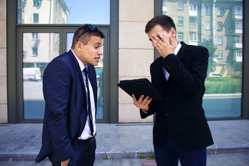 two men are engaged in a dialogue near the business center