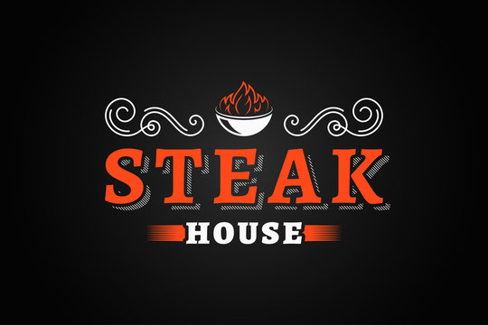 steak house vintage logo with fire flame on black background