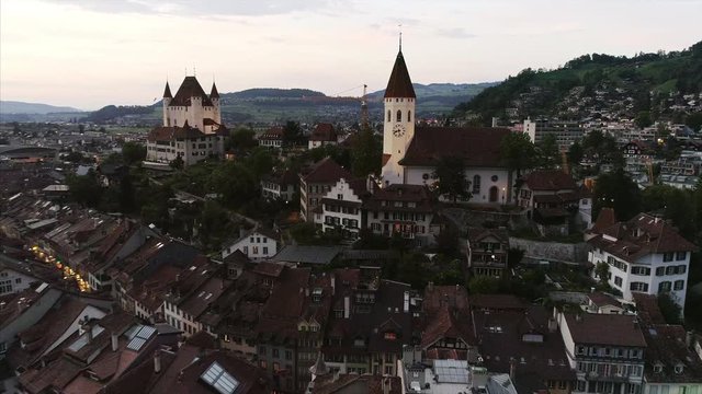 Backward drone shot of Thun City, Switzerland. Footage captures the architecture of the old town, Thun City bridge and Castle.