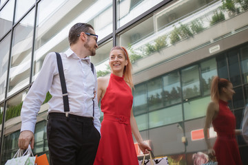 Cheerful elegant couple shopping together.