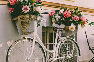 Fototapeta na wymiar soft focus concept of vintage white cycle with flowers and 