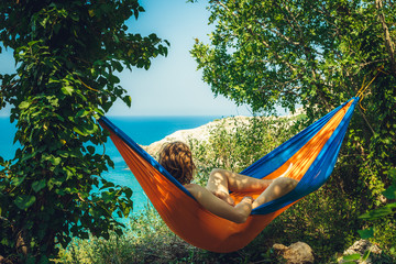 person relaxing in hammock