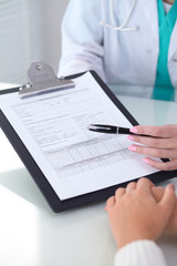 Fototapeta premium Doctor and patient, close-up of hands. Physician talking about medical examination results. Medicine, healthcare and helping concept