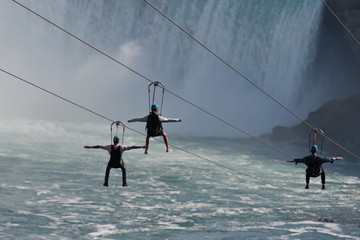 Young people sliping on a rope over the niagara falls