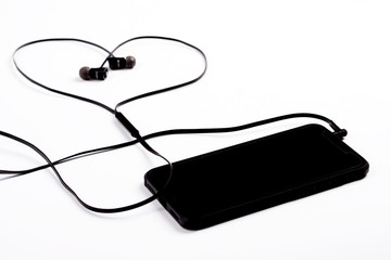 Black phone with headphones in the shape of a heart.