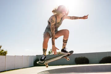 Foto op Aluminium Women skater doing ollie on skateboard © Jacob Lund