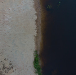 top view to bending river in green forest  on sunse