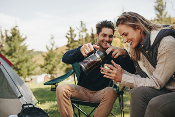 Couple at their campsite having coffee