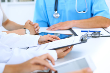 Group of doctors discussing diseases and treatment at medical meeting. Medicine concept