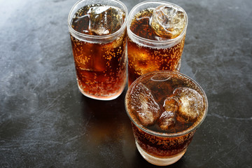 Soft drinks Ice tube in glass On the black table