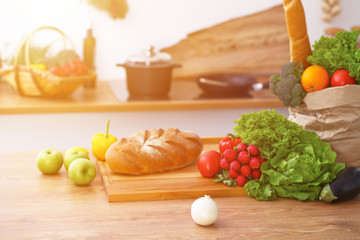 Desk  with many fresh vegetables and fruits in the kitchen. Cooking, vegetarian and shopping concept.