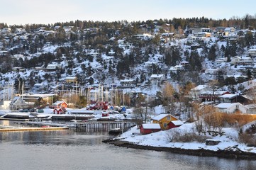 Colorful houses on fjord in Oslo, Norway- with beautiful sky and sea in the morning