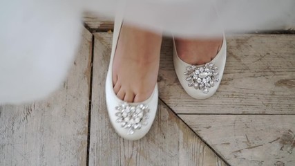 Bride put on bridal shoes