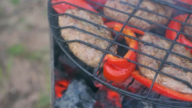 Cutlet from fried meat on grill with Bulgarian red sweet pepper. The products are roasted separately, without mixing. A good dish for a mixed group of people from meat-eaters and vegetarians.