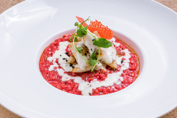 red risotto with squid